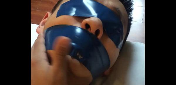  Chinese slave boy Tied up and tightly tape gagged with blue PVC tape